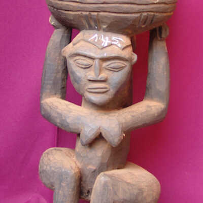 Female figure holding a container