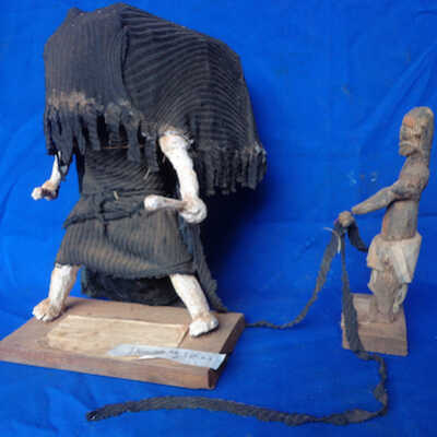 Figure of masquerade and attendants