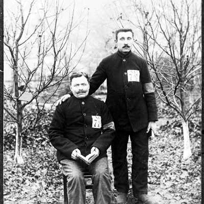 Two Men Wearing Uniform Coats