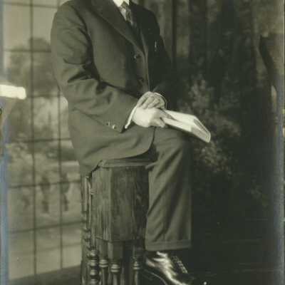 Man Wearing Spectacles Holding a Book