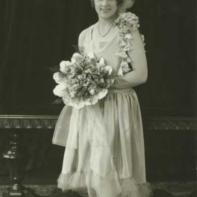 Young Lady Holding Bouquet of Flowers