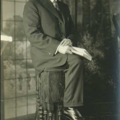 Man Wearing Spectacles Holding a Book