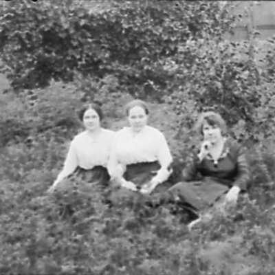 Three Women Sitting on Ground