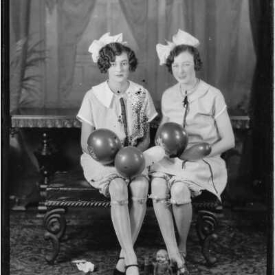 Two Women Holding Balloons