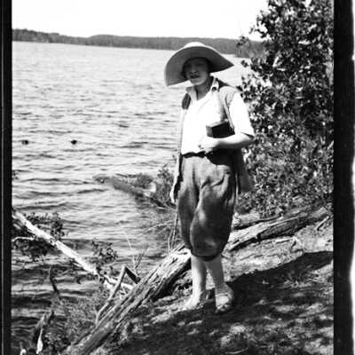Woman Wearing Hat Next to Lake
