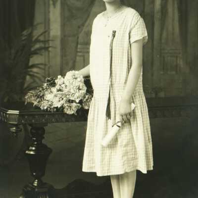 Young Lady Holding Rolled Paper (Diploma?)