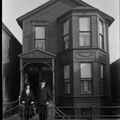 Couple in Front of House