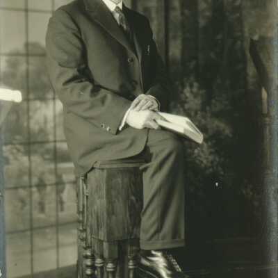 Man Wearing Spectacles Holding a Book