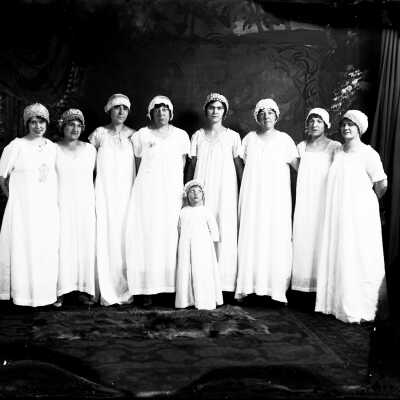 Women and Girl in Shifts(?) Wearing Caps
