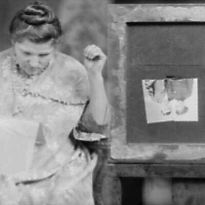 Woman Reading (?) with Photo Upside Down