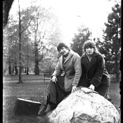 Two Women Sitting on Boulder