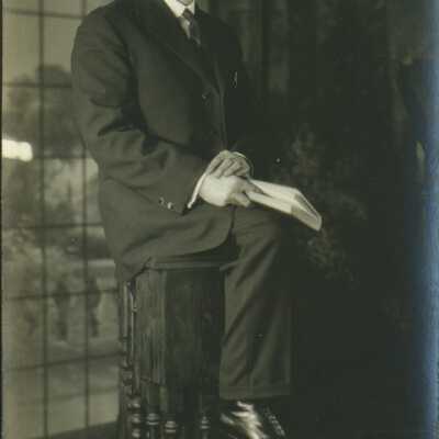 Man Wearing Spectacles Holding a Book