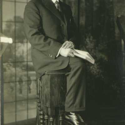 Man Wearing Spectacles Holding a Book