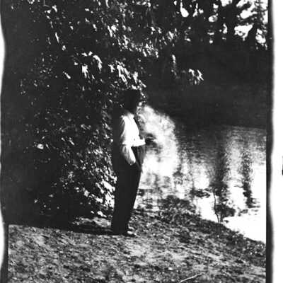 Man Standing Next to Lake