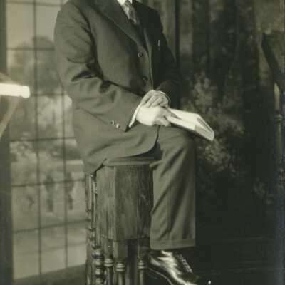 Man Wearing Spectacles Holding a Book