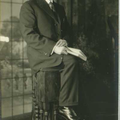 Man Wearing Spectacles Holding a Book