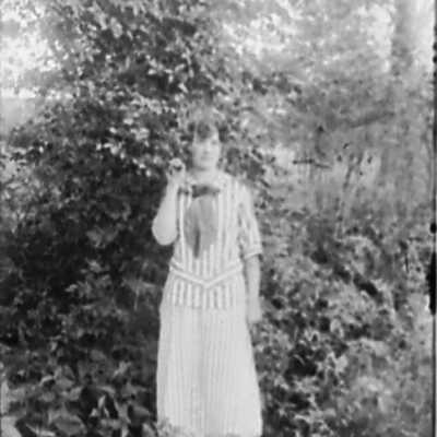 Woman in Striped Blouse and Skirt