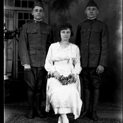 Two Soldiers and Woman Holding Roses