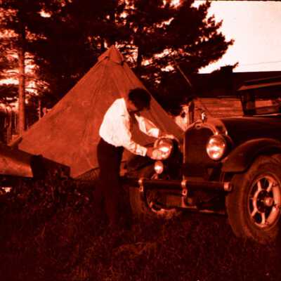 Man Cleaning Headlamp of Auto