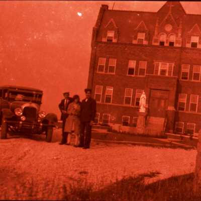 Four People with Auto Outside of Catholic Institution