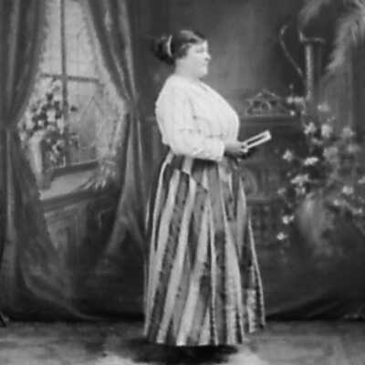 Woman Wearing Striped Skirt Holding Photograph