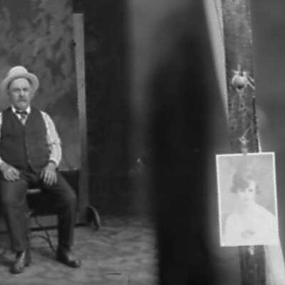 Photo of Man Sitting with Photo of Woman