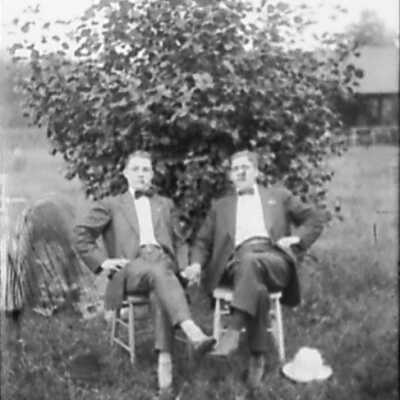 Two Men Sitting In Chairs