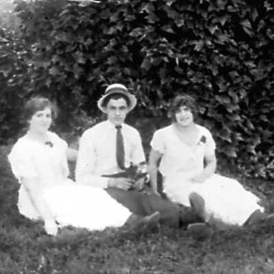 Man Wearing Hat and Two Women