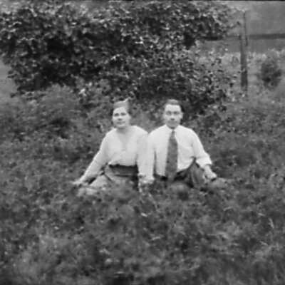 Man and Woman Sitting On Ground