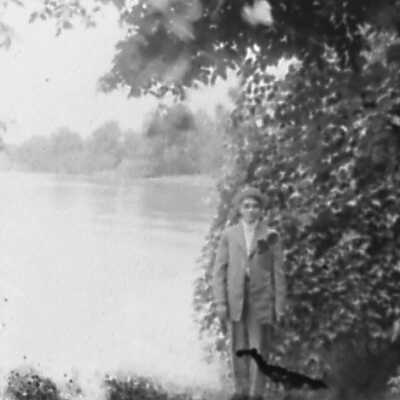 Man Standing Next to Lake