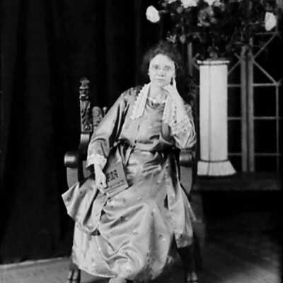Woman Sitting and Holding a Book