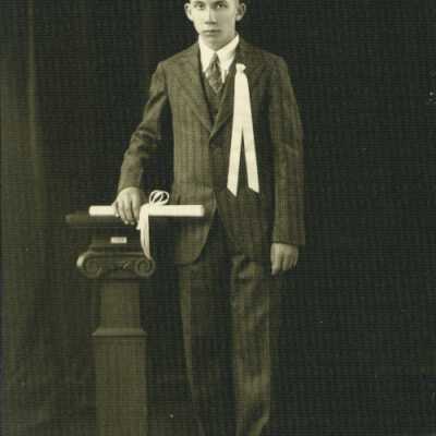 Young Man Holding Rolled Paper (Diploma?)