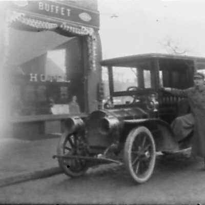 Chauffer and Car in Front of Hotel