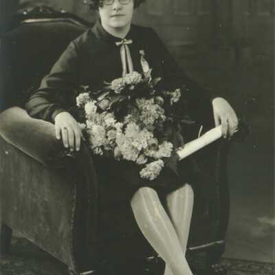 Young Lady Wearing Spectacles and Holding Rolled Paper (Diploma?)