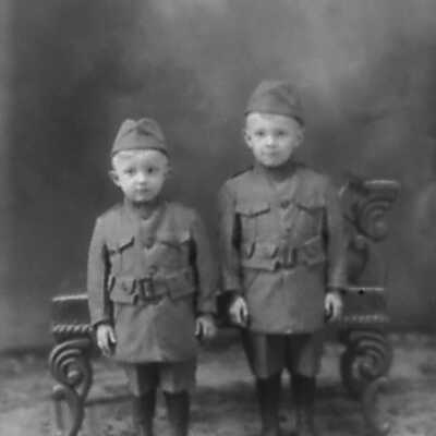 Two Boys Dressed in Soldier-like Uniforms