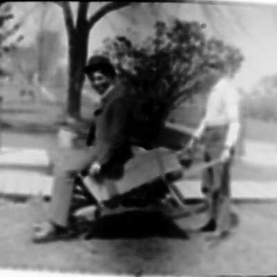 Nick Olsen pushing himself in a wheelbarrow