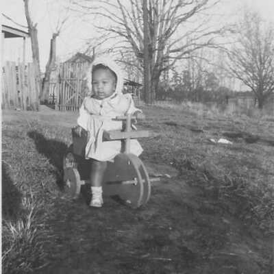 Connie riding a wooden push bike: Page 2