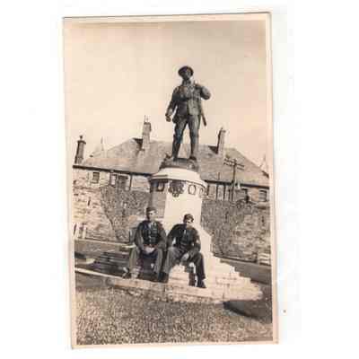 Postcard of Servicemen sitting on WWI Monument in England