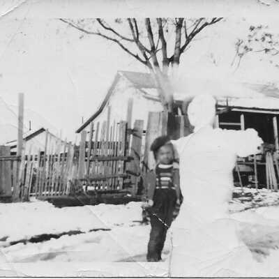 Connie standing next to a snowman: Page 3