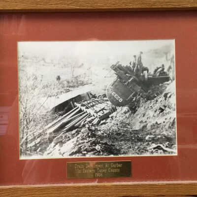 Framed photo and news report of train derailment at Garber, MO on Nov 29, 1915, inaccurate plaque