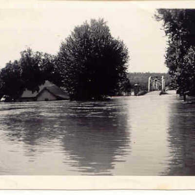 Photo of Arnold family house at White River Bridge during a flood in Forsyth, MO