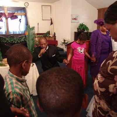 New Hope Baptist Church Minister and Congregants Praying