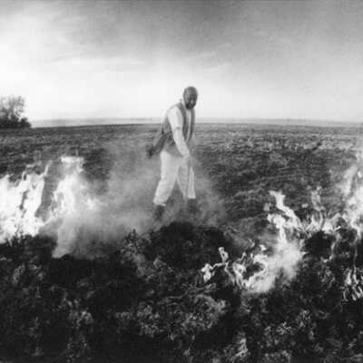 Richard Bresnahan With His Apprentices 1994 Preparing Flax Straw for Pottery glazes Leo and Hilda Moch Farm Kidder County Northeast of Braddock, North Dakota