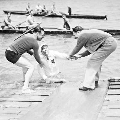 Boat Captain Jim Albers being pulled to safety by Lawton Hughes (left)