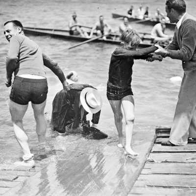 Club president Al Schneider being pulled out of the water