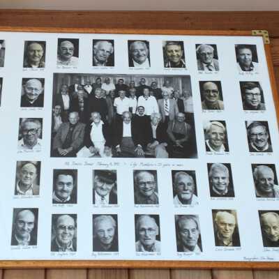 Framed group & individual photos, east wall Sancimino Room July 2021