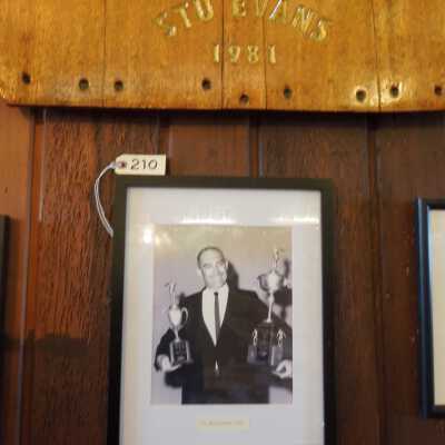 Framed photo of Stu Evans hanging under name board