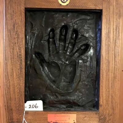 Photo of Dino Landucci and Bronze mold of right hand