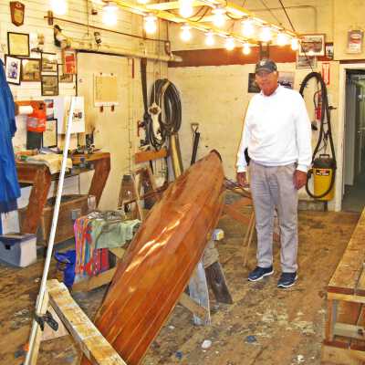 Richard Cooper with skiff in workshop