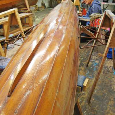 Davis Ja with skiff in workshop